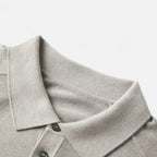 Knit polo sweater with button placket and classic collar, styled for a refined casual look
