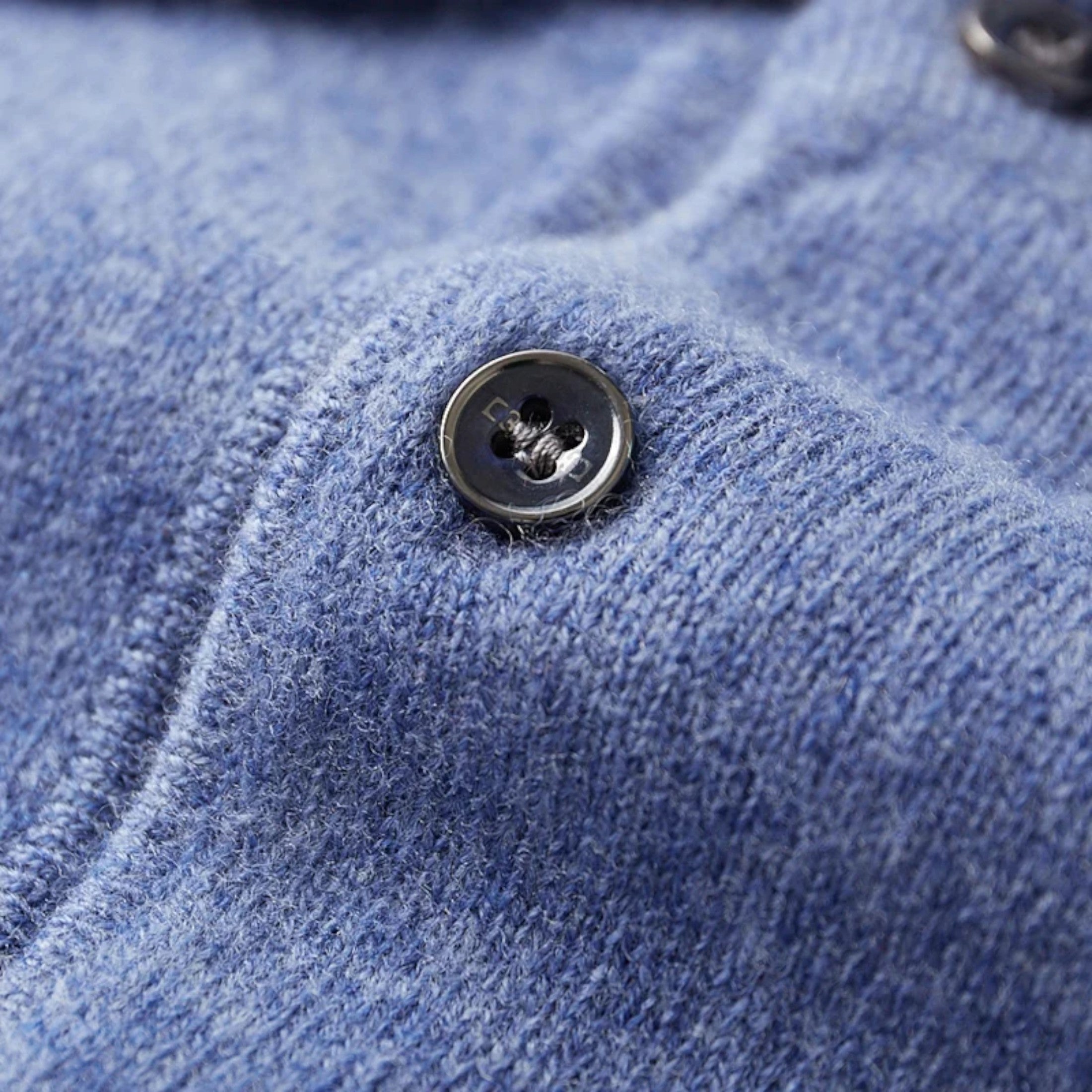 Knit polo sweater with button placket and classic collar, styled for a modern casual look
